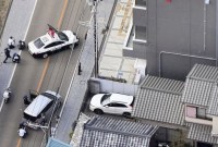 BERITA lokal sebelumnya melaporkan bahwa sekitar 10 staf kantor pos mungkin berada di dalam gedung. (AP Photo/Kyodo News)