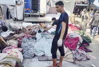 RS Al Shifa di Gaza mengungkapkan 120 jenazah akan dikubur di kompleks RS Al Shifa, Gaza, di tengah pengepungan pasukan Israel. (AFP/KHODER AL-ZAANOUN)
