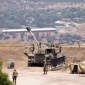 Tentara Israel berdiri di dekat kendaraan artileri self-propelled di pinggiran Kiryat Shmona dekat perbatasan Israel dengan Lebanon. [AFP/Jalaa Marey]