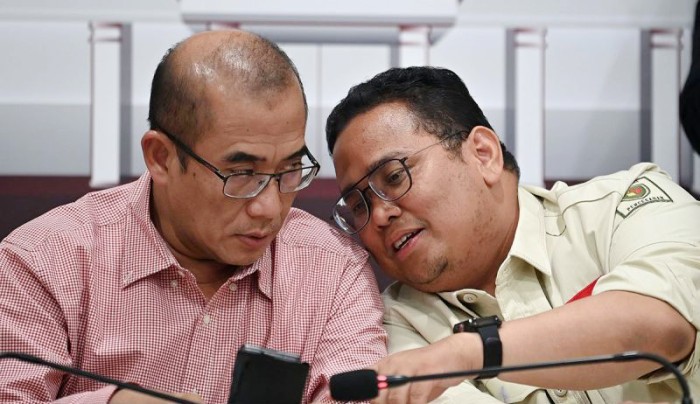 Ketua KPU Hasyim Asy'ari (kiri) berbincang dengan Ketua Bawaslu Rahmat Bagja (kanan) di sela konferensi pers terkait perkembangan rekapitulasi suara Pemilu 2024 di Kantor KPU, Jakarta, Kamis (15/2/2024). KPU saat ini telah menyerap data dokumen penghitungan suara atau C1 melalui Sistem Informasi Rekapitulasi (Sirekap) dari berbagai TPS sebanyak 358.775 dari 823.236 dokumen atau setara dengan 43,58 persen. [ANTARA FOTO/Aditya Pradana P]