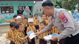 Anggota Satlantas Polres Balangan memberikan buku bergambar tentang rambu lalu lintas sebagai alat peraga edukasi kepada siswa TK Cempaka, Kecamatan Paringin Selatan, (SuarIndonesia/Adv)