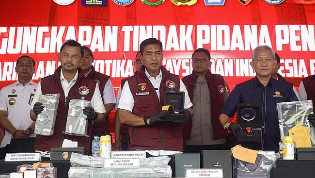 Kabareskrim Komjen Wahyu Widada (tengah) bersama Dirjen Bea Cukai Askolani (kanan) dan Direktur Tindak Pidana Narkoba (Dirtipidnarkoba) Bareskrim Polri Brigjen Mukti Juharsa (kiri) dan pimpinan berbagai lembaga menunjukkan barang bukti tindak pidana pencucian uang (TPPU) dari kejahatan narkoba, di Lapangan Bhayangkara Mabes Polri, Jakarta, Rabu (18/9/2024). (detikcom/AriSaputra)