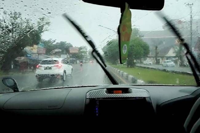 Foto Ilustrasi - Pengendara melintasi jalan raya saat hujan lebat mengguyur wilayah Kota Palangka Raya, Kalimantan Tengah. (ANTARA/Rendhik Andika)
