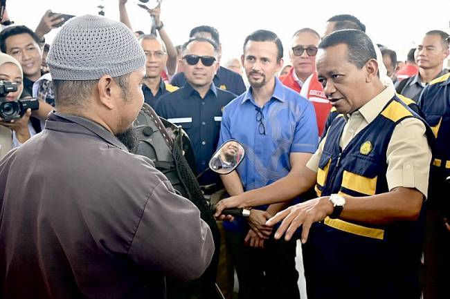 Menteri Energi dan Sumber Daya Mineral (ESDM) Bahlil Lahadalia (kanan) berdialog dengan pembeli Bahan Bakar Minyak (BBM) Pertalite RON 90 dalam kunjungan kerja di SPBU Banjarbaru, Kalimantan Selatan, Rabu (19/3/2025). (Foto: ANTARA/Tumpal A Aritonang)