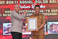 Bupati Balangan menerima secara simbolis bantuan bedah rumah untuk warga Balangan dari Kapolda Kalsel. foto: MC Balangan