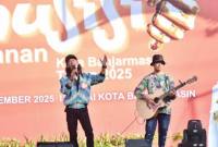 Dua musisi jalanan Banjarmasin saat tampil dalam lomba nyanyi sebagai ruang mereka berkreasi di panggung perayaan Harjad Ke-499 kota setempat di panggung Siring Sungai Martapura Banjarmasin, Selasa (9/9/2025). (SuarIndonesia/Humas Pemko Banjarmasin)