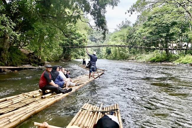 Para wisatawan menaiki Bamboo Rafting menyusuri Sungai Amandit yang membelah hutan tropis di Desa Lok Lahung, Kecamatan Loksado, Kabupaten Hulu Sungai Selatan, Kalimantan Selatan, Senin (20/10/2025). (ANTARA/Abdul Hakim)