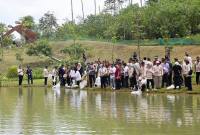 Sejumlah orang menebarkan benih ikan di salah satu badan air di KIPP IKN di Kecamatan Sepaku, Kabupaten Penajam Paser Utara, Provinsi Kalimantan Timur. (Foto: Antara/Nyaman Bagus P)